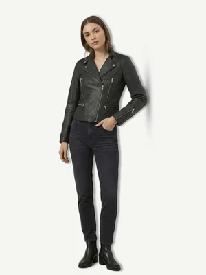 Model wearing the Tomb Raider style black biker jacket with dark wash straight-leg jeans and black ankle boots